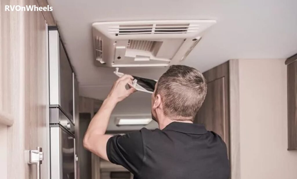 The man is fixing RV AC Air Handler. It is for the section of troubleshooting common problems.